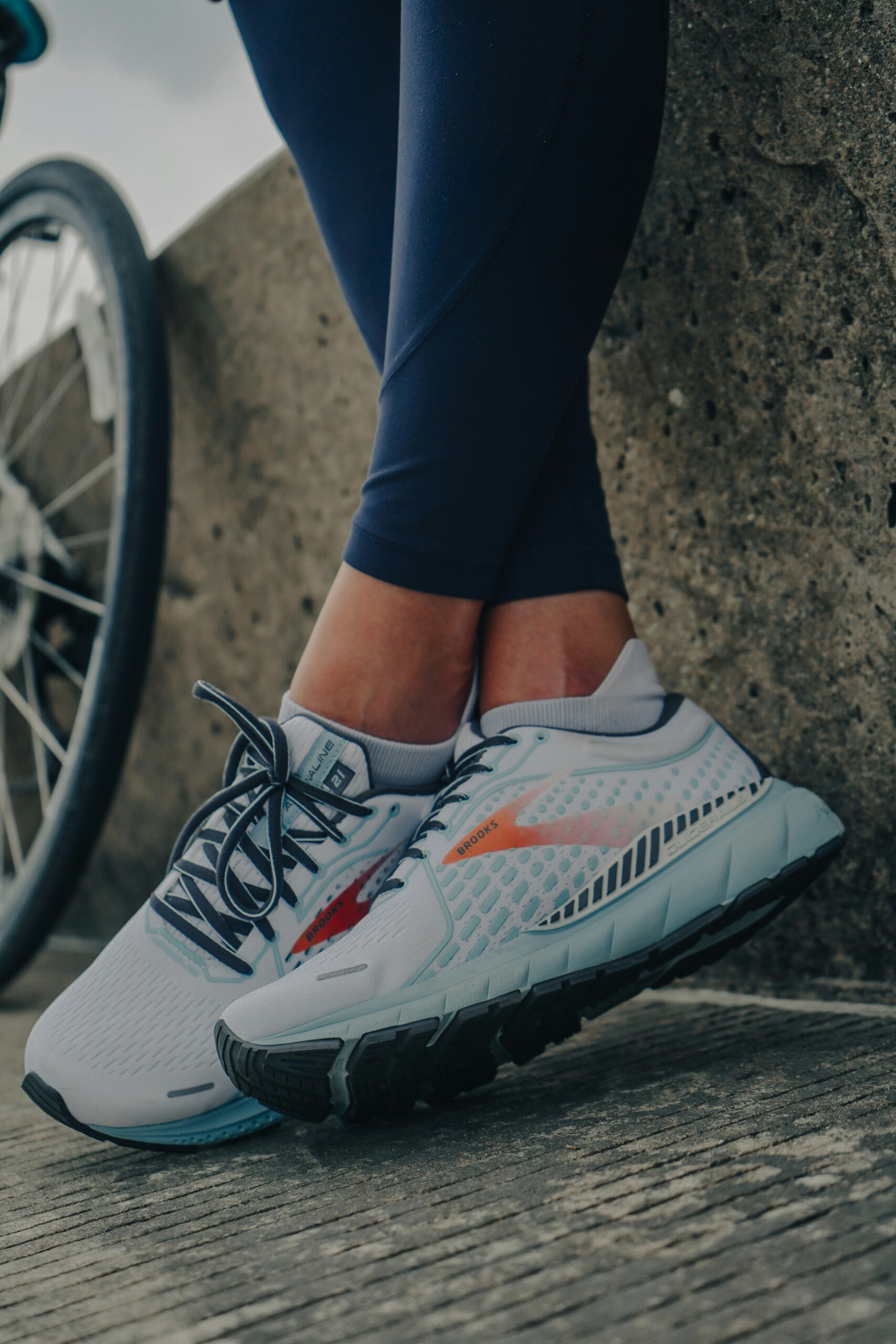 legs with sneakers on and blue leggings