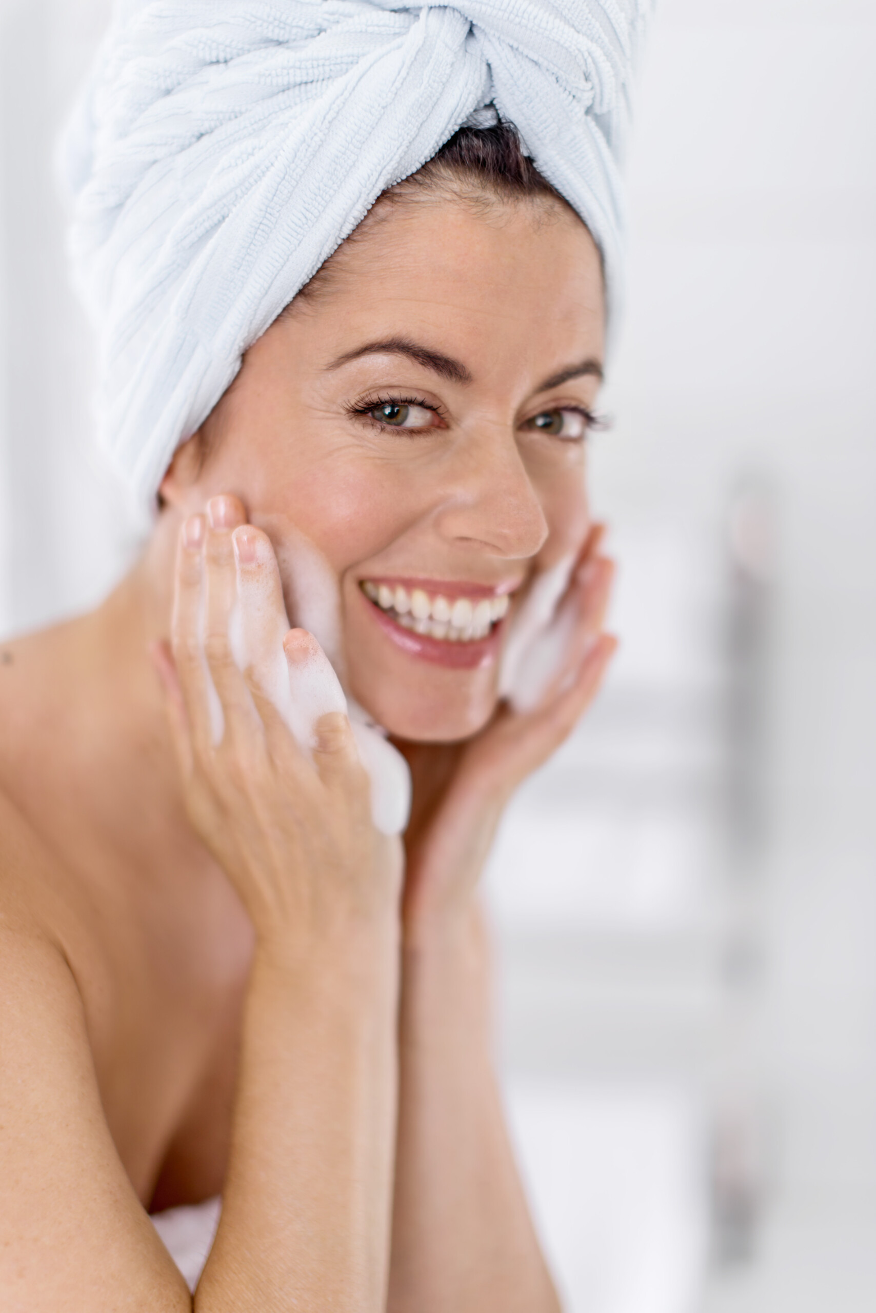 woman with white towel smiling